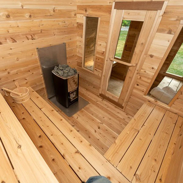 Rustic cabin sauna interior with spacious seating in natural cedar.