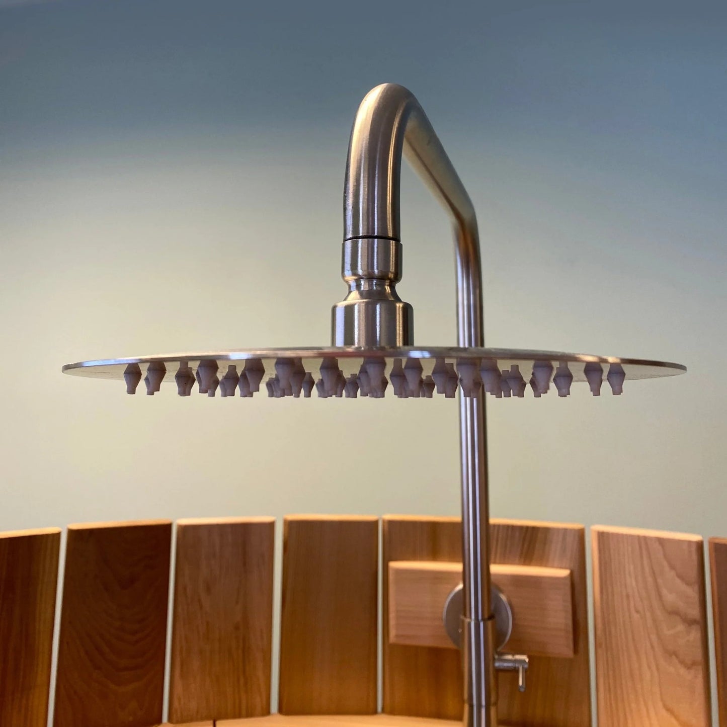 Backyard cedar shower stall with natural wood finish.